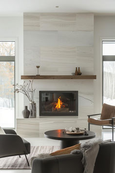 40 Stylish Modern Mantel Decor Designs for an Elegant Home Modern Chimney Ideas Living Rooms, Modern Fireplace With Hearth, Decorating Fireplace Mantel, Lakehouse Fireplace, Tv Unit Table, Fireplace Round, Modern Stone Fireplace, Modern Fireplace Ideas Living Rooms