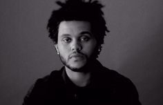 a black and white photo of a man with dreadlocks