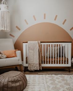 a baby's room with a crib, chair and rug