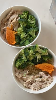 two white bowls filled with different types of food next to each other on a table