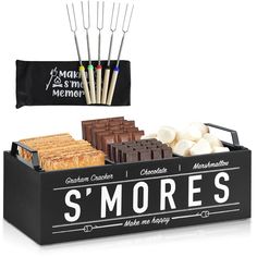 there is a black box with sweets and marshmallows in it that says s'mores