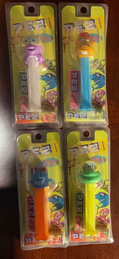 three toy toothbrushes in plastic packaging on a table