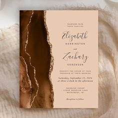 an elegant wedding card with gold foil on the front and back, featuring a watercolor background