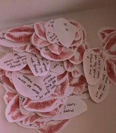 a bunch of paper hearts with writing on them