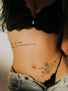 a woman with a tattoo on her stomach