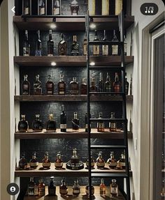 the shelves are filled with bottles of liquor