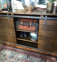 an old trunk is sitting on top of a cabinet in a room with rugs