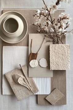 the table is set with white flowers, napkins, and other things on it