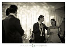 a man and woman standing next to each other in front of a table with food