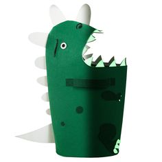 a green paper dinosaur with its mouth open