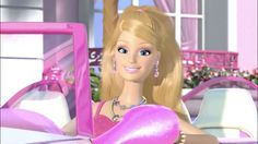 the barbie doll is holding a pink heart shaped object in front of her face and dress