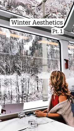 a woman sitting at a table in front of a window with the words winter aesthetics pt 1