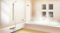 a bath tub sitting next to a window in a bathroom with beige tile on the floor