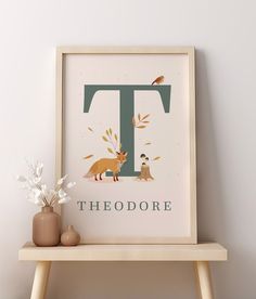 there is a poster with the letter t on it next to a vase and flowers