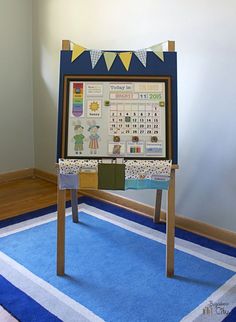 a wooden easer with a calendar on it in front of a blue and white rug