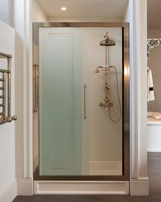 a walk in shower sitting inside of a bathroom