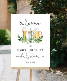 a welcome sign with beer mugs and greenery on the bottom, in front of a tree