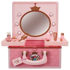 a pink vanity with a mirror and other items on it's shelf, all in the shape of a princess castle