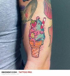 a woman's arm with an ice cream sundae tattoo on her left arm