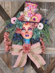 a woman's head is adorned with flowers and doughnuts as she sits in front of a wooden wall