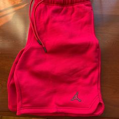 Brand New Never Worn Red Jordan Shorts With Drawstring And Pockets Sporty Red Loungewear Bottoms, Red Cotton Sporty Bottoms, Red Shorts With Elastic Waistband For Loungewear, Red Loungewear Shorts With Elastic Waistband, Red Elastic Waistband Shorts For Loungewear, Red Sports Pants For Summer, Red Athletic Shorts For Loungewear, Red Cotton Bottoms With Built-in Shorts, Red Cotton Athletic Shorts With Built-in Shorts