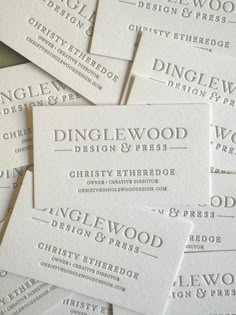 white business cards stacked on top of each other with the words dinglewood design and press printed on them