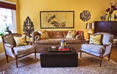 a living room with yellow walls and furniture