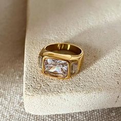 a gold ring sitting on top of a white pillow