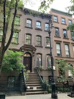 an apartment building with stairs leading up to the front door