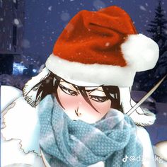 a woman wearing a santa hat and scarf with snow falling down on her head in the background