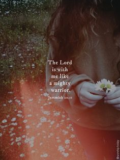 a girl holding a flower with the words, the lord is with me like a mighty warrior