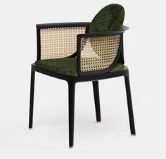 a black chair with green and white upholstered fabric on the armrests