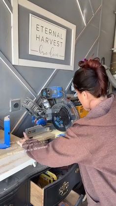 a woman working on a piece of wood