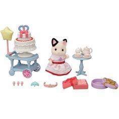 an assortment of toys including cake, tea set and doll