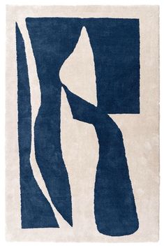 a blue and white rug with an abstract design on the bottom, in front of a white background