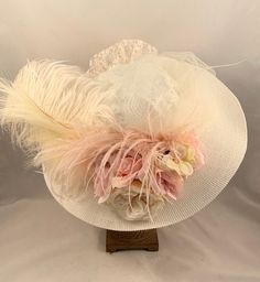 "VICTORIAN WIDE BRIM HAT - #1320 Off WhiteHat with ivory and pink blush accents. This style is our Wide Brim Off White hat with ivory and pink blush accents with ivory and pink blush flowers, tulle, lace covered crown, lace bow and feathers. SIZE:  Medium,  22\" - 22 1/2\" inches for the head circumference.                          Hat sizing can be provided if need to make it smaller. Please message me.                          You must measure your head to make sure the hat will fit. This hat Kentucky Derby Hats For Women, Chic Hat, Edwardian Hat, Hat With Flowers, Victorian Accessories, Material Flowers, Pretty Hats, Victorian Hats, Ascot Hats