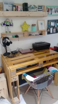 a desk made out of pallet wood with a laptop on it