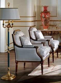 a living room filled with lots of furniture and a lamp on top of a table