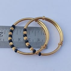 925 Sterling Silver Gold Polished Traditional Nazariya Baby Bangles Baby Kade Black & Silver Beads Silver Gold Polished Bangles  Size 1 : 0 - 2 Year Baby, Weight : 12 Gram Size 2 : 2 - 5 Year Baby, Weight : 14 Gram See More Gemstone :  https://www.etsy.com/in-en/shop/silveriumjewels P R O D U C T I O N ~ T I M E S ~ Every single item we sell is handcrafted to order with care. :) Please check individual items and our policies page for the most recent production updates. S H I P P I N G ~ We offer Stackable Bangle With Round Beads For Gift, Stackable Bangle With Round Beads As Gift, Adjustable Gold Jewelry For Birthday, Gold Stackable Beaded Bracelets For Birthday, Gold Bangle Bracelet For Birthday, Gold Stackable Bracelets For Birthday, Adjustable Round Gold Bracelet Stackable, Gold Bead Bracelet Gift, Handmade Gold Bracelets For Birthday