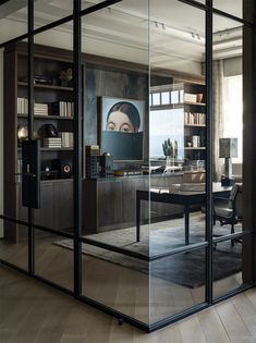 an office with glass walls and wooden floors