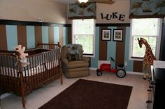 a baby's room with a giraffe stuffed animal in the crib