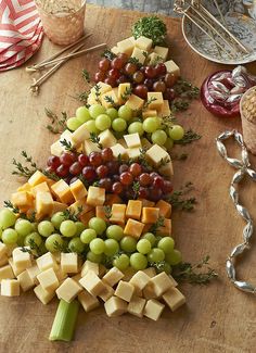 a christmas tree made out of cheese and grapes