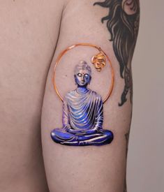 a man with a tattoo on his arm has a blue buddha sitting in a circle