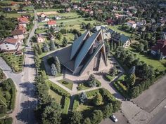 an aerial view of a church surrounded by trees