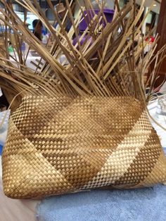 a basket that is sitting on top of a blue towel with some plants in it