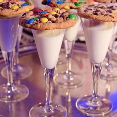 desserts are served in wine glasses on a table