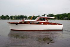 a red and white boat is in the water