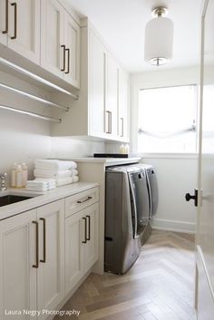 a washer and dryer in a white kitchen