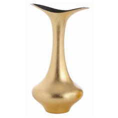 a gold vase sitting on top of a white table