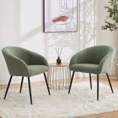 two green chairs sitting on top of a white rug